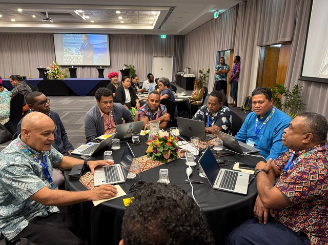Group of people discussing with laptops on a table